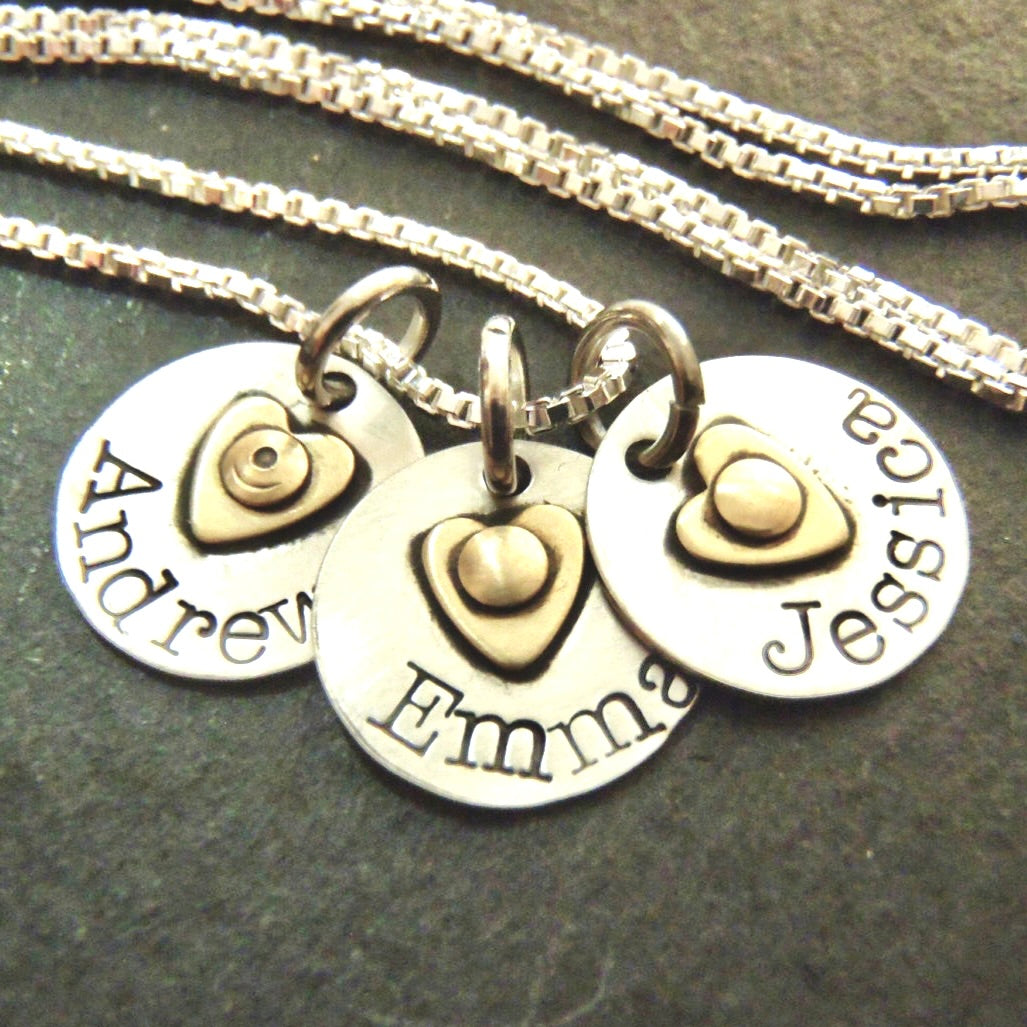 Sterling silver mom necklace with Kids names and golden brass heart. Names are hand stamped in typewqriter font - Drake designs jewelry