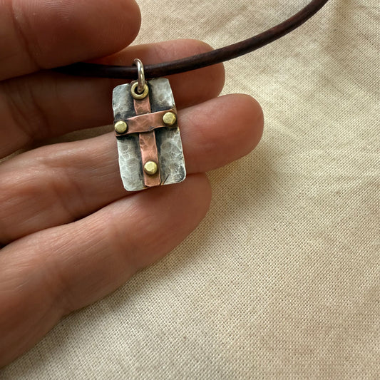 sterling silver and copper cross pendant with golden brass rivets. Hammered rustic cross necklace for men or women hand crafted by Drake Designs Jewelry