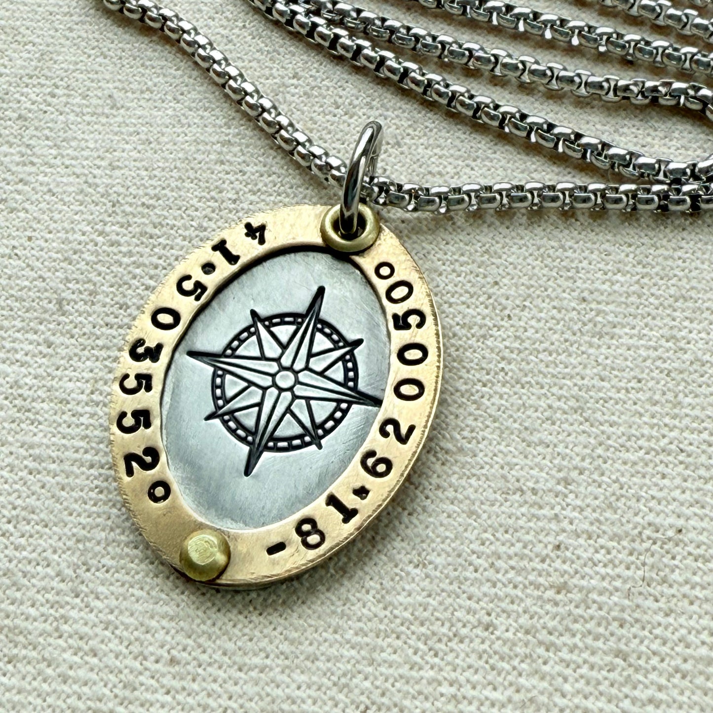 Oval Gold Rimmed custom coordinates necklace with compass rose at center hand stamped and riveted by hand - drake designs jewelry