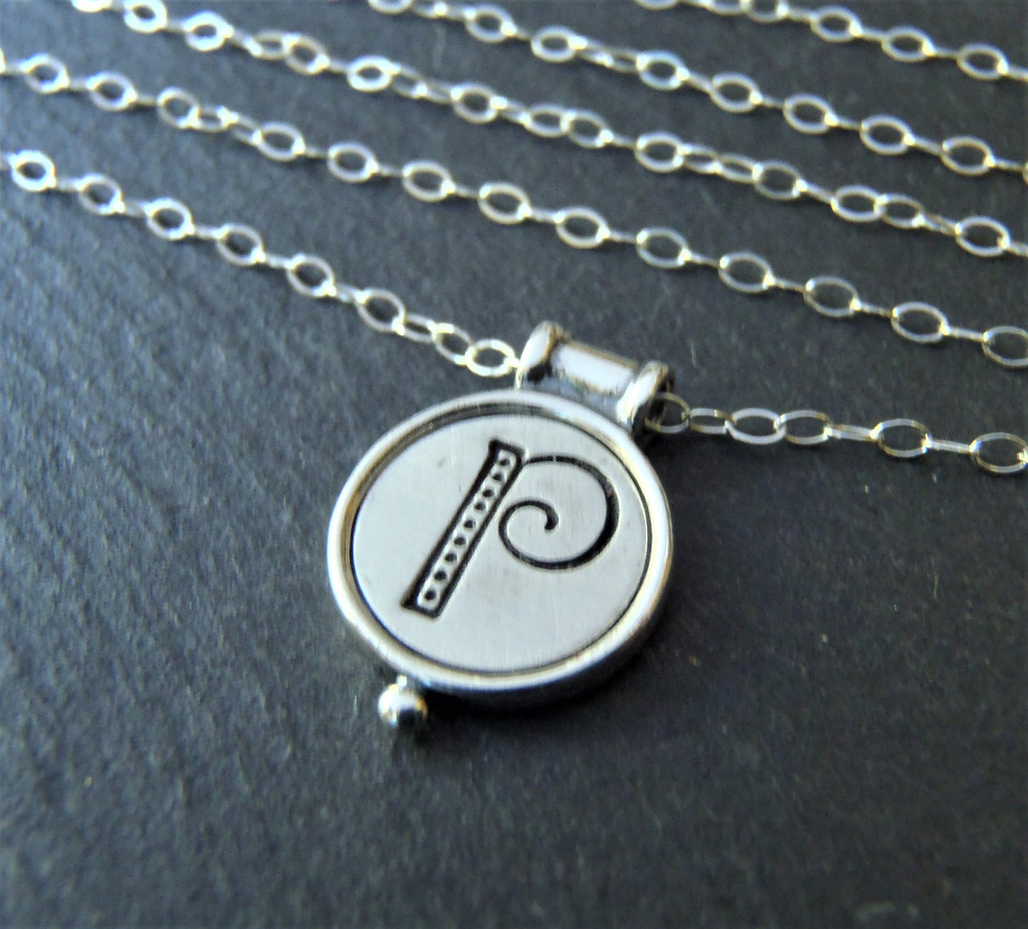 A sterling silver necklace with a personalized initial pendant on a cable chain - drake designs jewelry