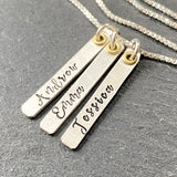 hand stamped sterling silver mom necklace with childrens names on thick bars mixed metal with gold accent. drake designs jewelry