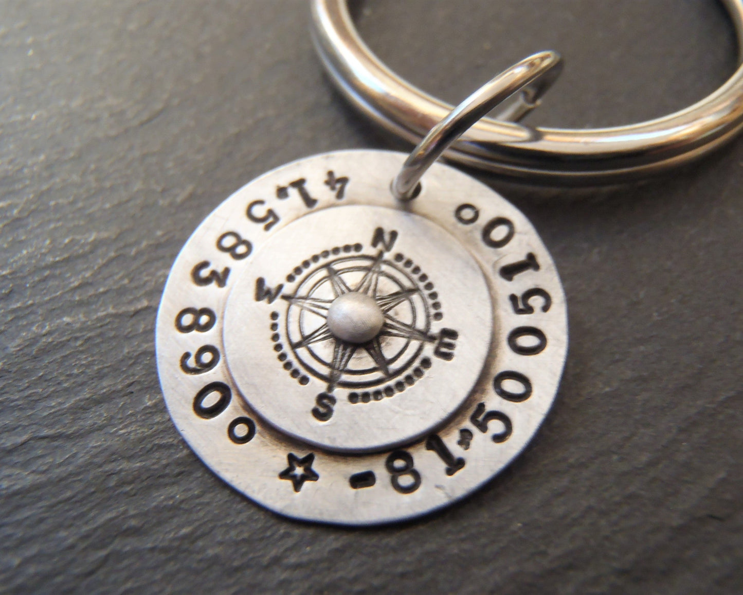 sterling silver keychain personalized with latitude longitude coordinates hand stamped with  riveted compass