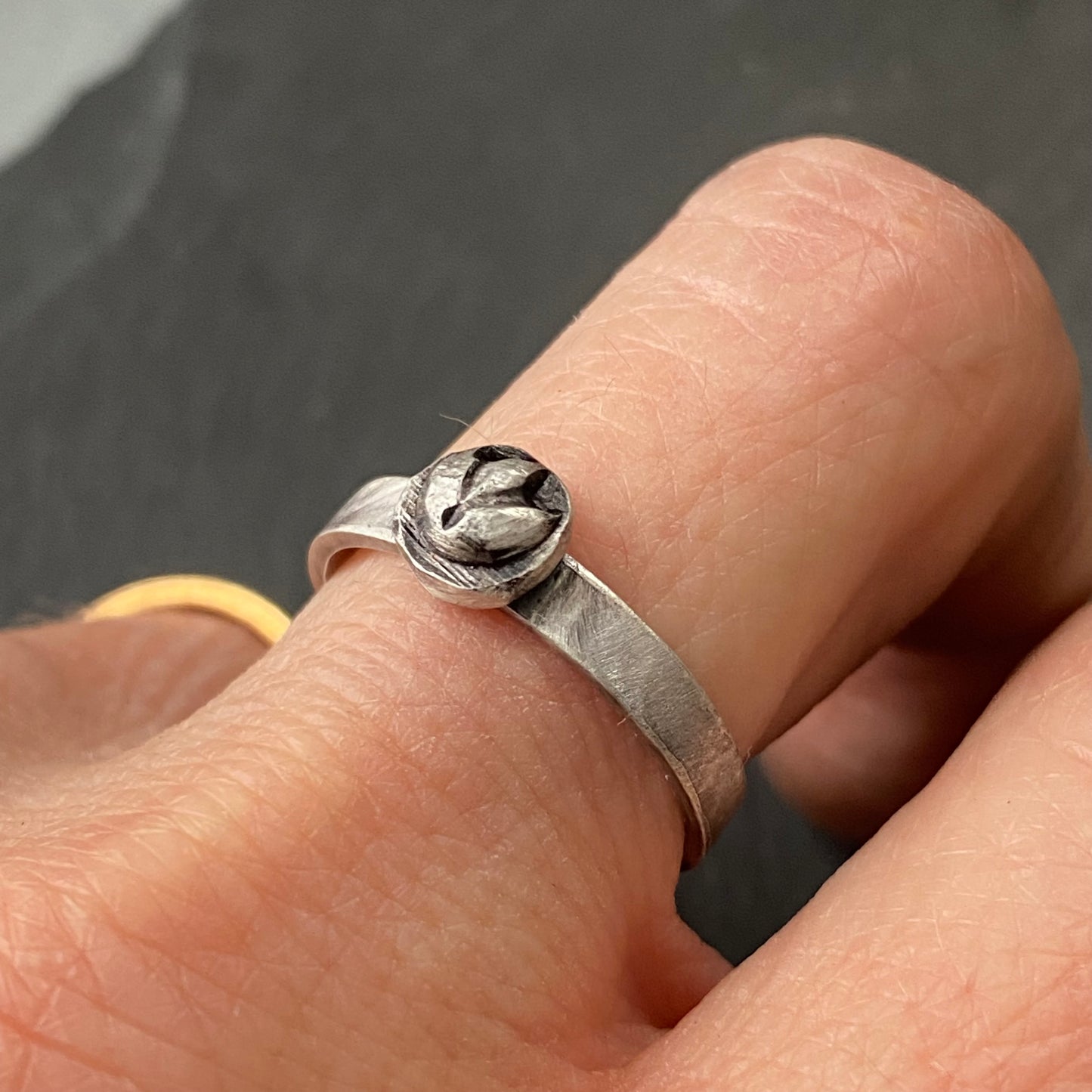 A sterling silver lotus flower organically shaped stacking ring with 'breathe' hand stamped inside, drake designs jewelry