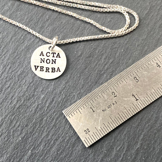 deeds not words hand stamped tiny Latin phrase necklace. Acta non verba inspirational hand crafted necklace. drake designs jewelry