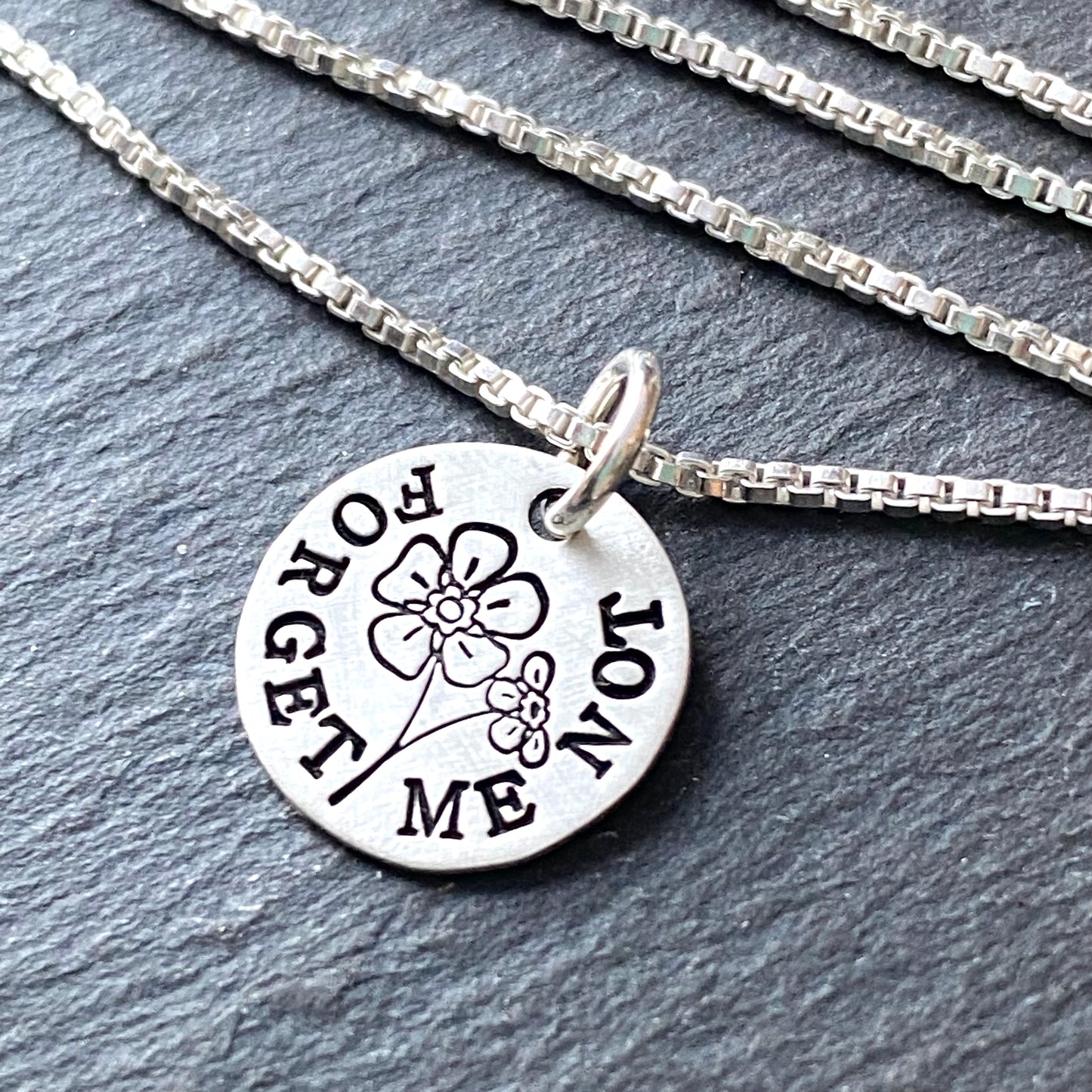 forget me not symbol of remembrance and love. sympathy gift for loss. Forget me not necklace hand stamped on sterling silver with brushed finish. drake designs jewelry