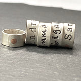 personalized sterling silver bead charm riveted by hand with copper rivet. Hand stamped on sterling silver with your choice of font. Custom sterling silver name charms - drake designs jewelry