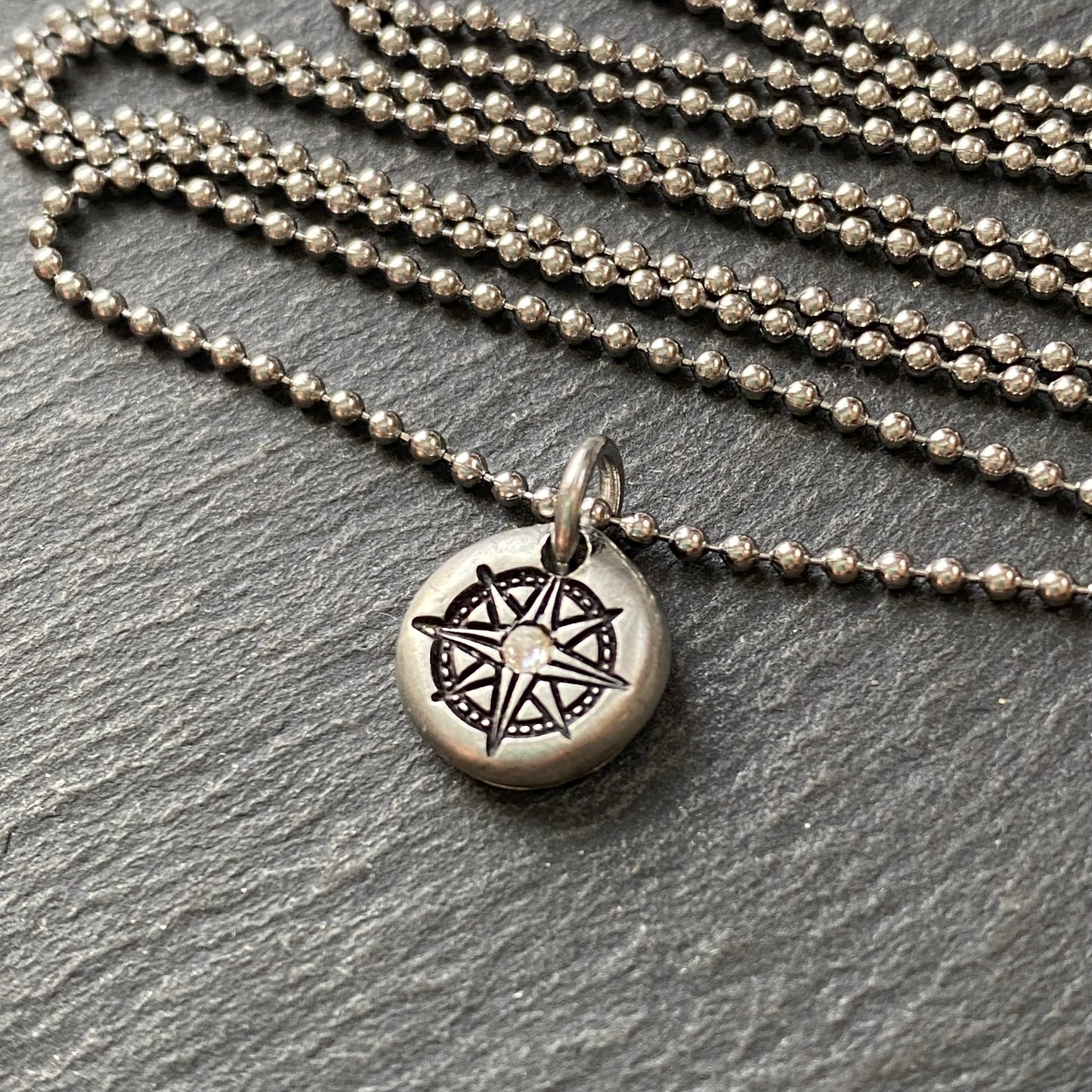 silver pebble compass necklace with hand set crystal at center - drake designs jewelry
