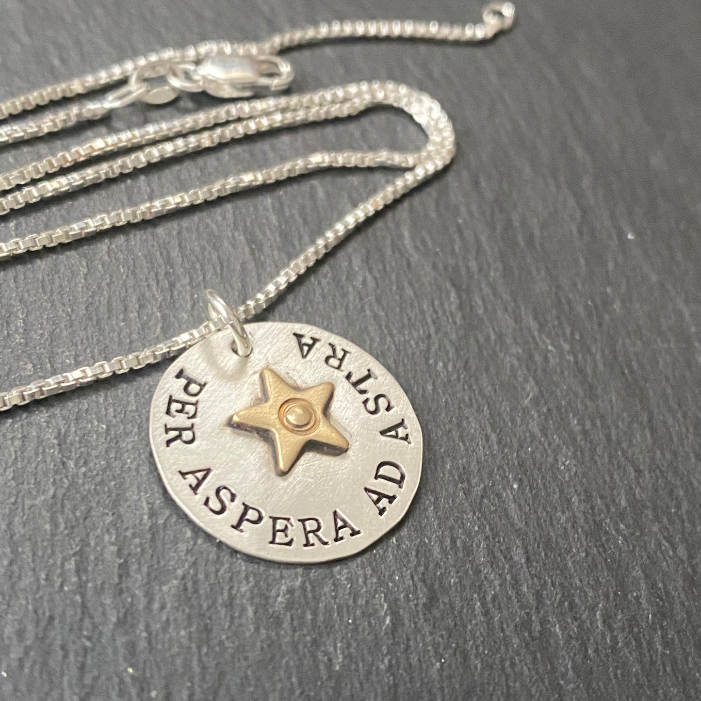 Per Aspera ad Astra Latin quote necklace hand stamped with riveted gold star. To the stars through hardships inspirational quote jewelry. Drake designs jewelry