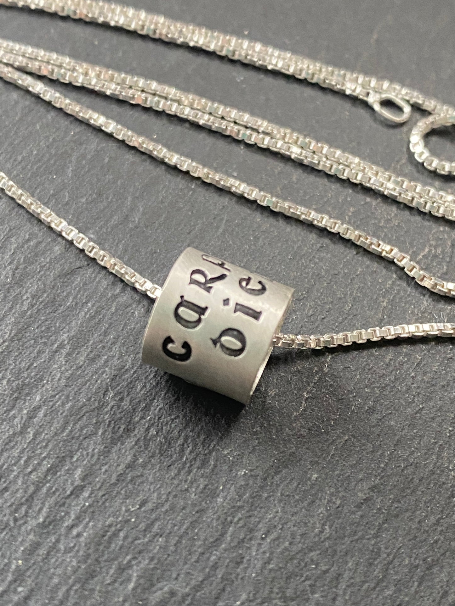 Carpe Diem in celtic font is hand stamped on sterling silver ring charm pendant. seize the day latin phrase ring charm necklace. drake designs jewelry