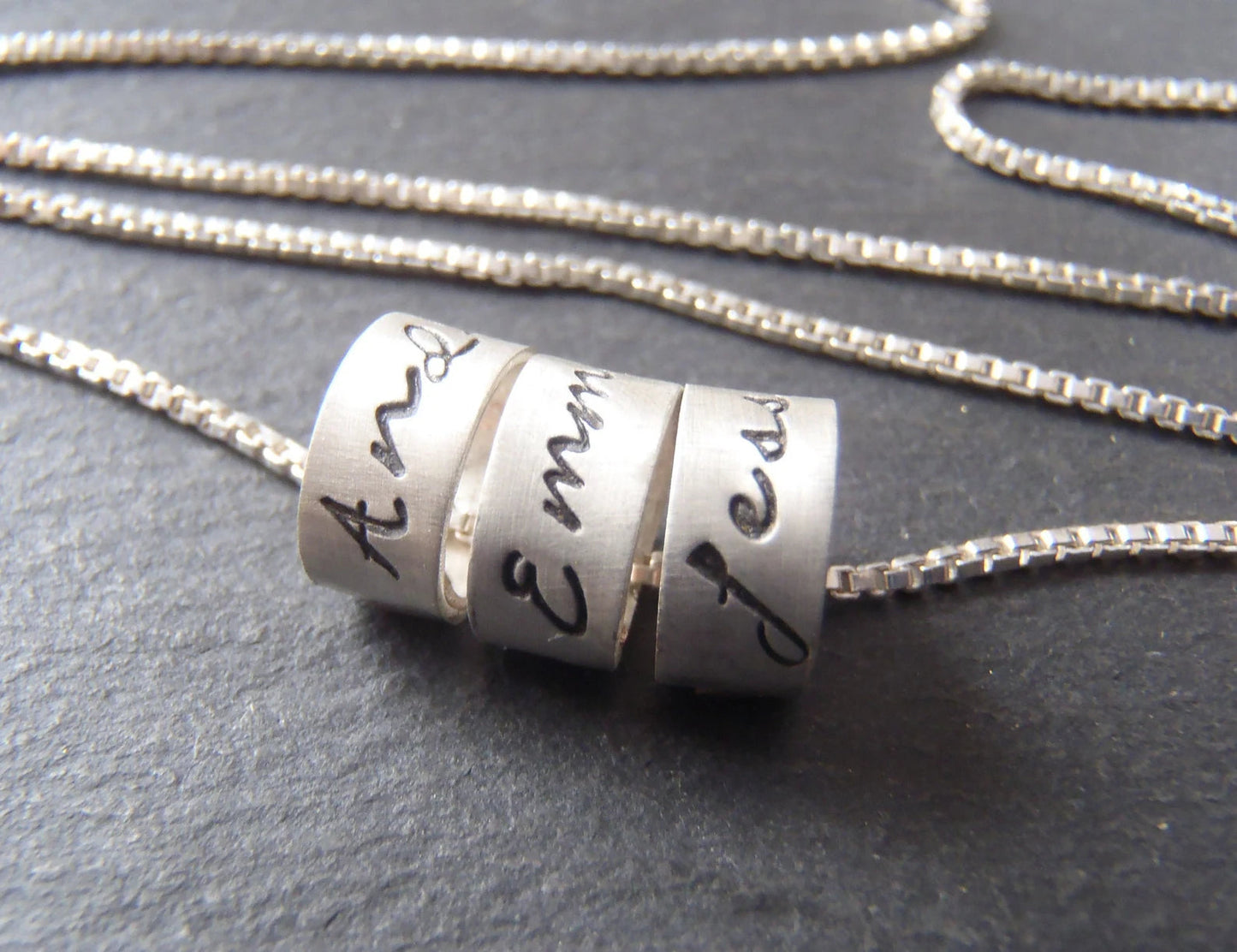sterling silver mom necklace with kids names in your choice of font on tiny ring charms. drake designs jewelry