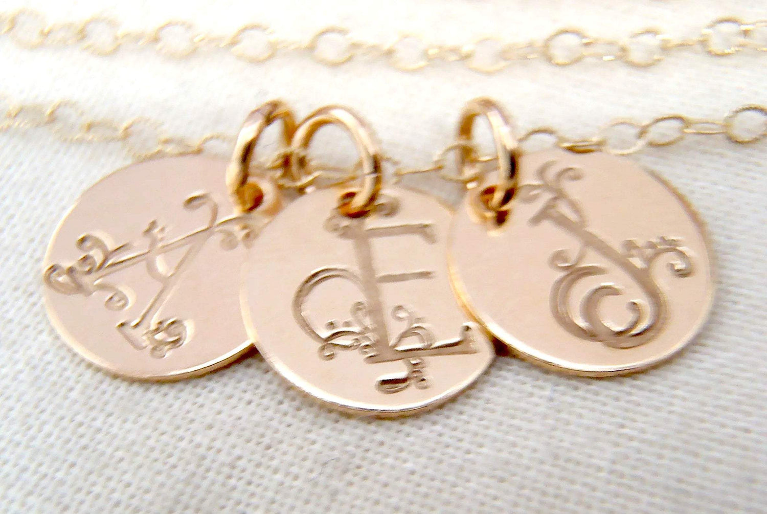 gold initial necklace with decorative art nouveau font