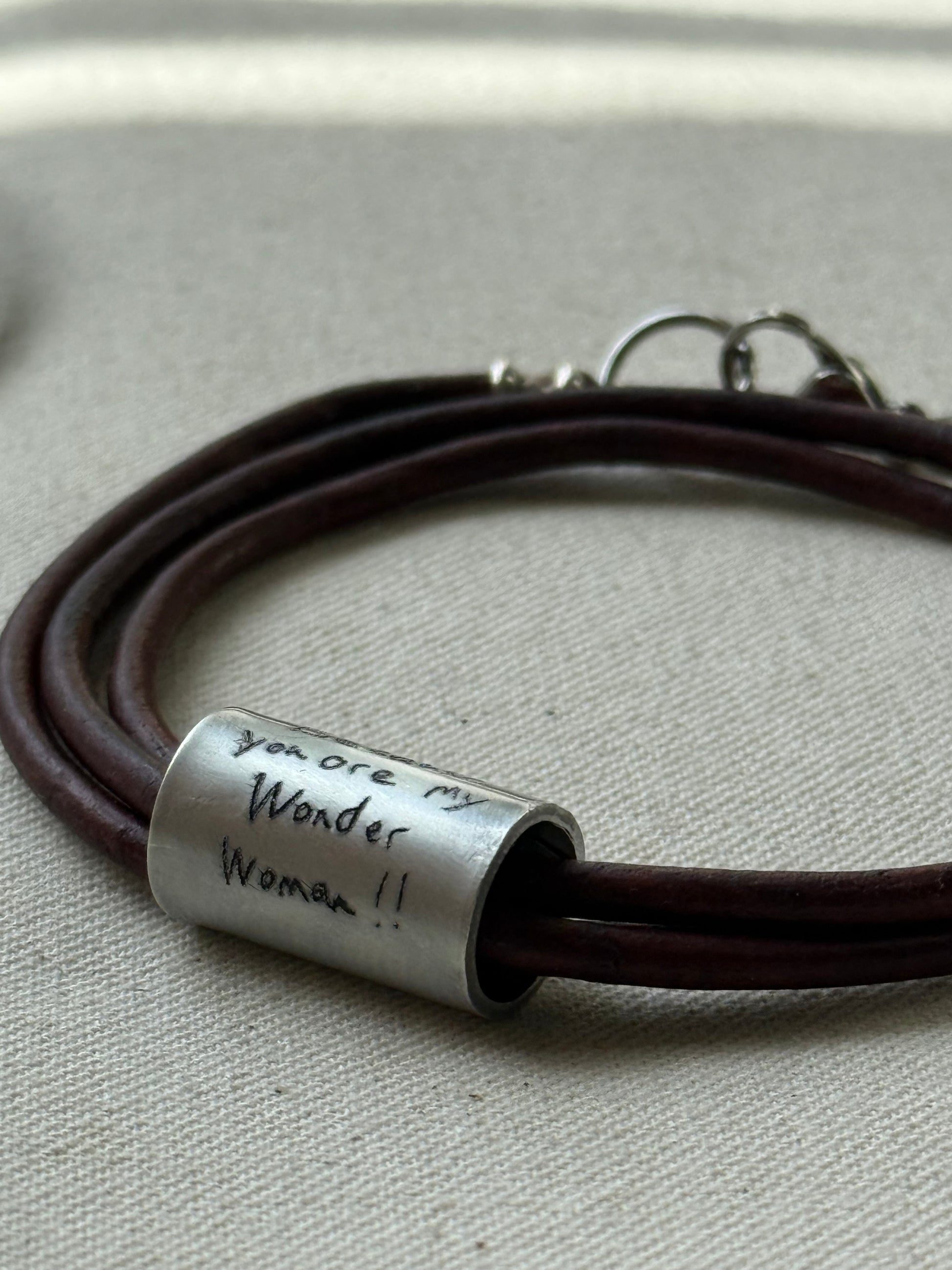 Leather bracelet with cylindrical pendant engraved with loved ones actual handwriting. - drake designs jewelry