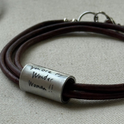 Leather bracelet with cylindrical pendant engraved with loved ones actual handwriting. - drake designs jewelry
