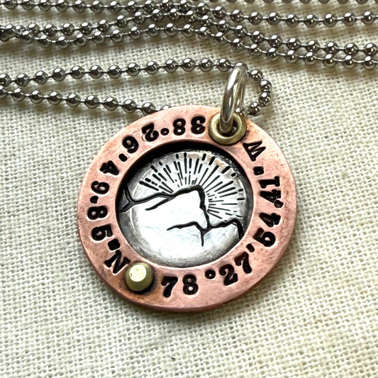 Personalized Mountain necklace with custom coordinates hand stamped on sterling silver and copper pendant.  Personalized latitude and longitude  hand crafted by drake designs jewelry