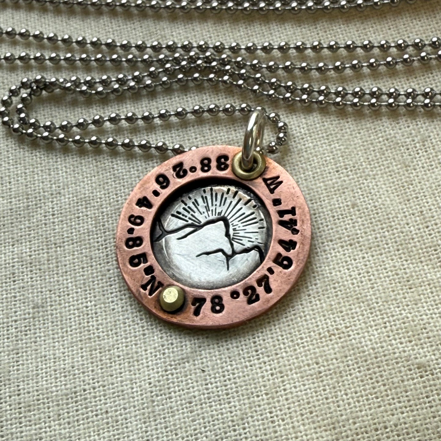 personalized mountain necklace sterling silver with copper and golden brass with custom latitude and  longitude hand crafted by drake designs jewelry