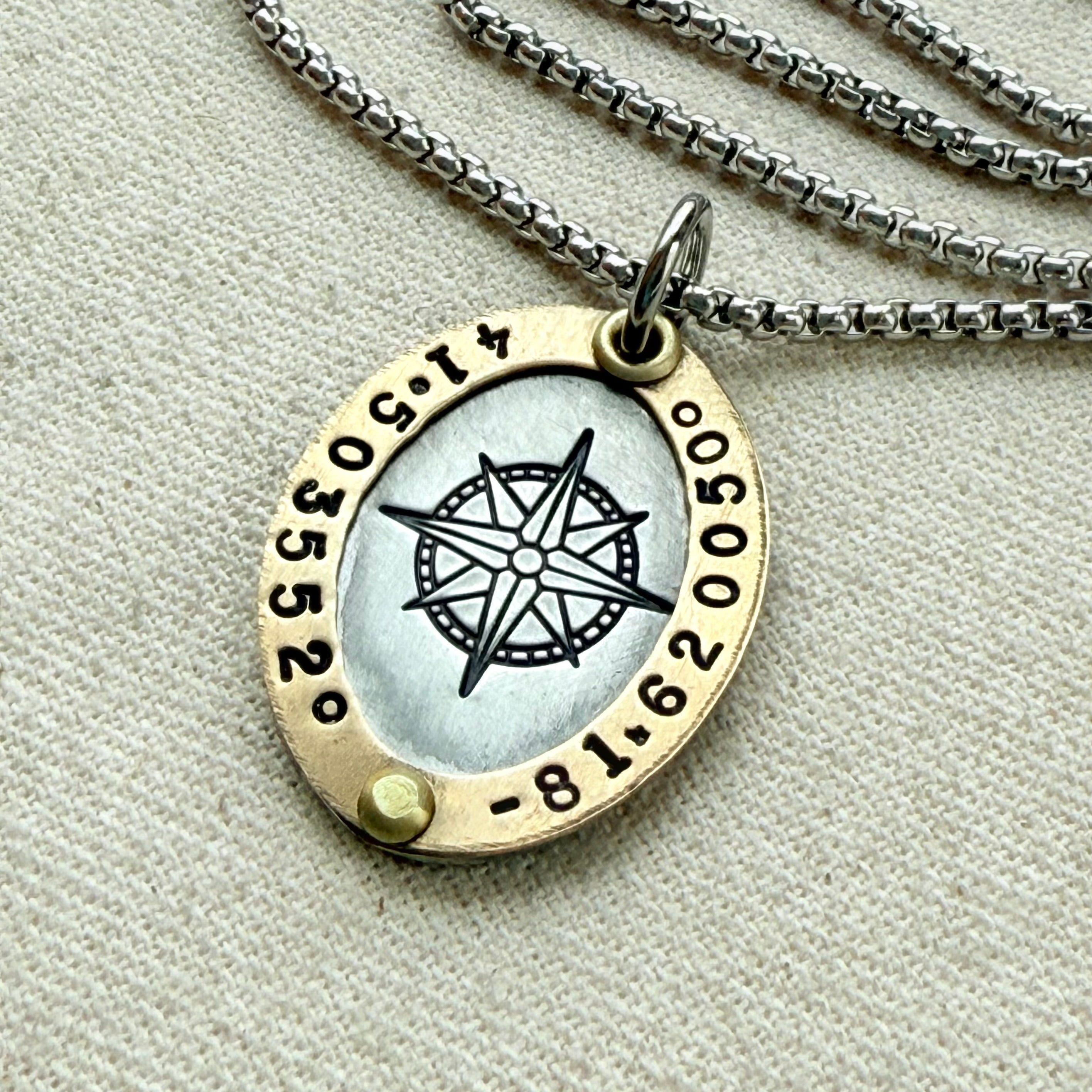 Personalized compass necklace with custom coordinates and raised gold border on oval pendant - drake designs jewelry