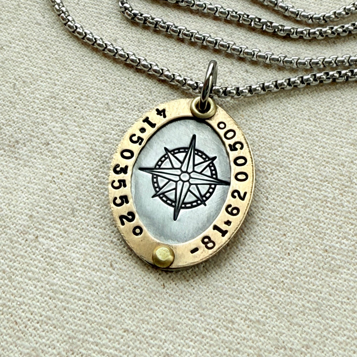 Gold Rimmed custom coordinates oval pendant necklace with compass rose at center hand stamped and riveted by hand - drake designs jewelry