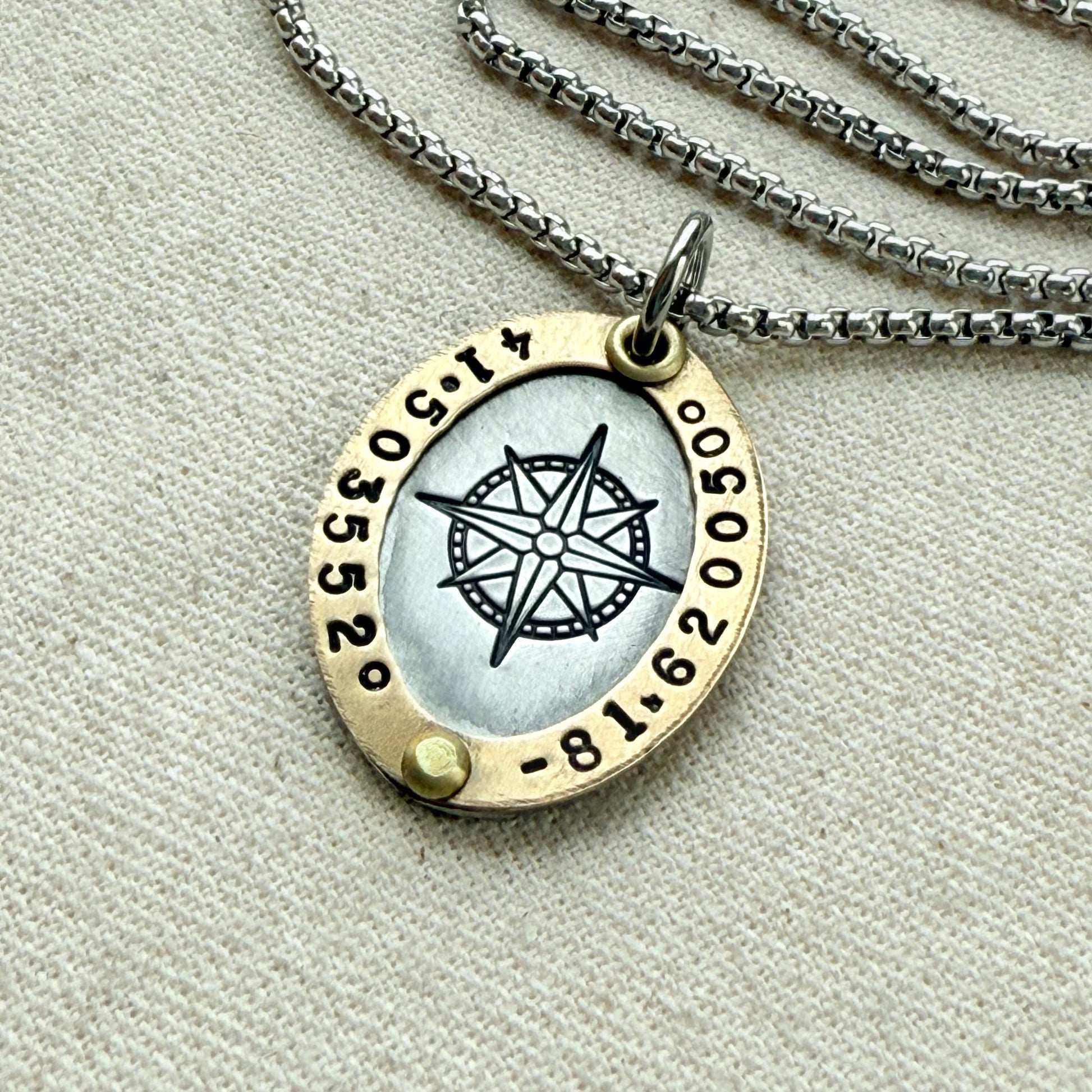 Oval Gold Rimmed custom coordinates necklace with compass rose at center hand stamped and riveted by hand - drake designs jewelry