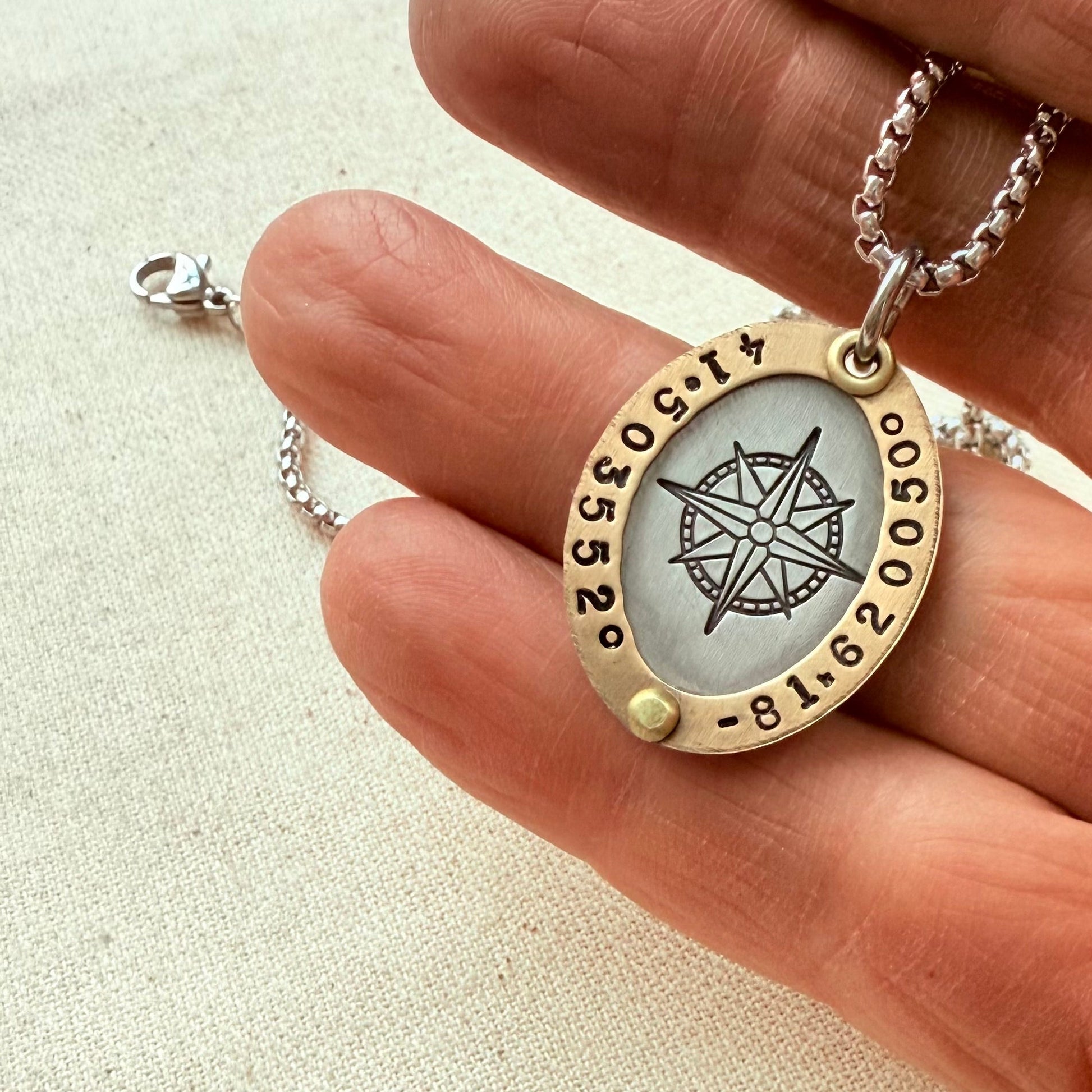 Oval Gold Rimmed custom coordinates necklace with compass rose at center hand stamped and riveted by hand - drake designs jewelry