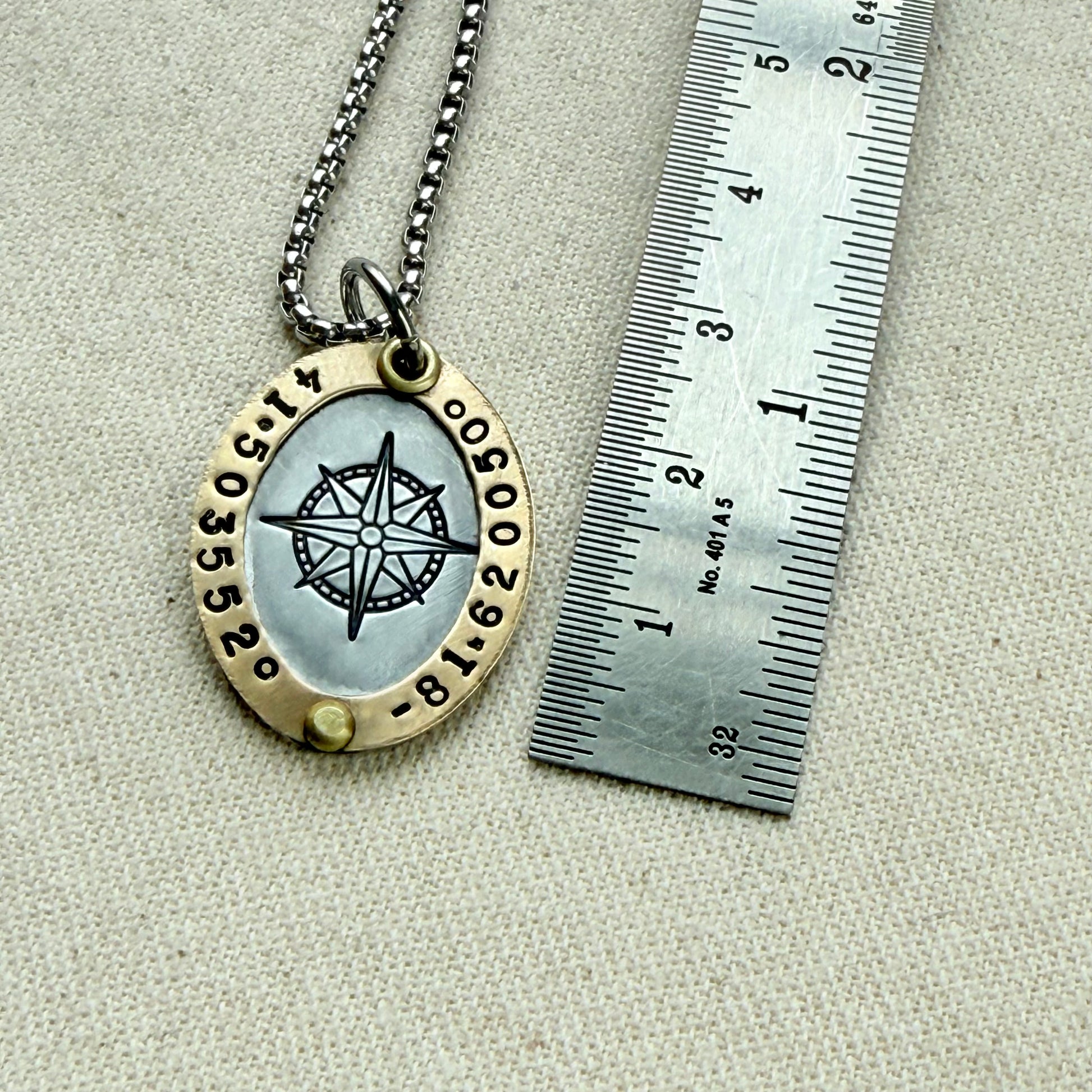 Oval Gold Rimmed custom coordinates necklace with compass rose at center hand stamped and riveted by hand - drake designs jewelry