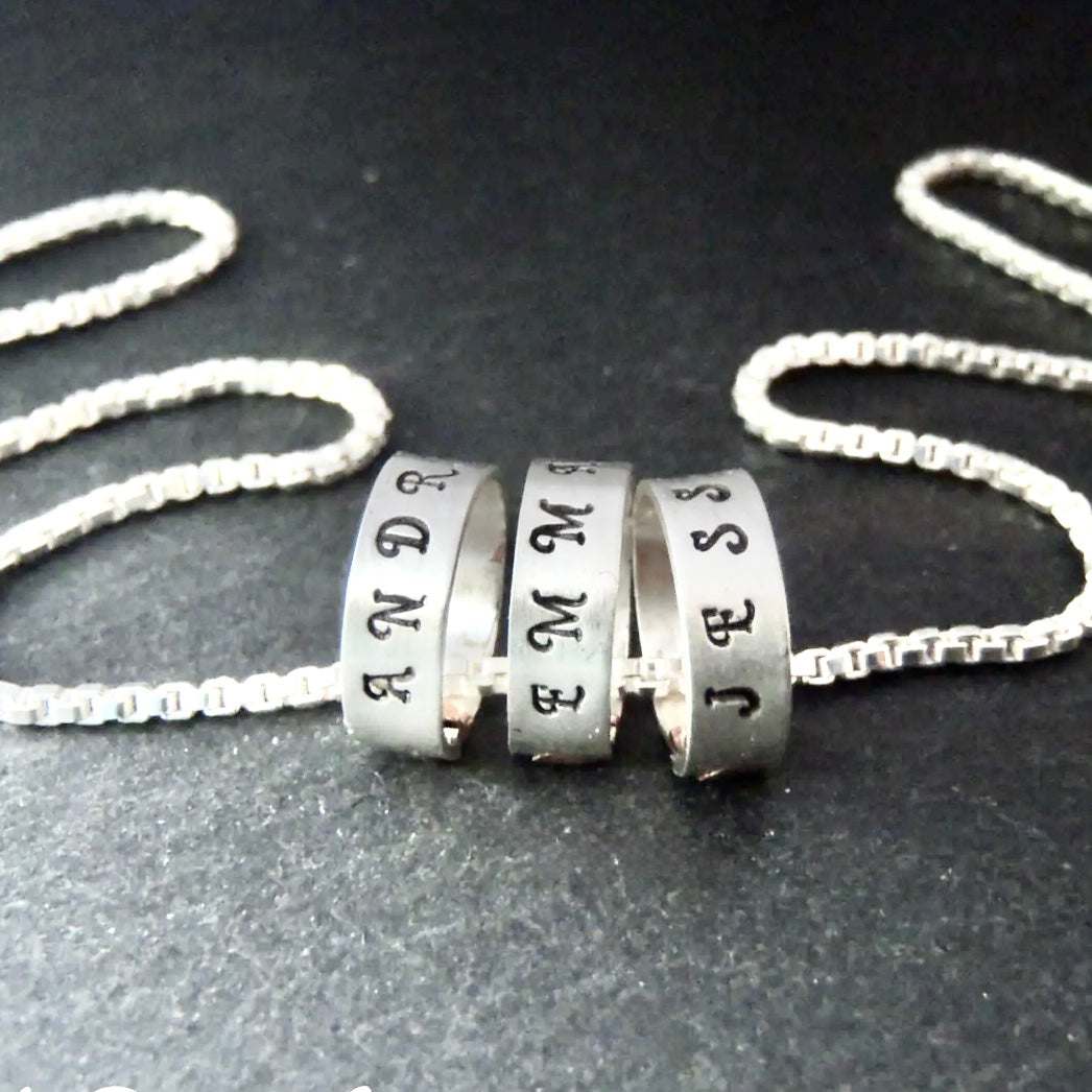 tiny hand stamped name charms on  Sterling silver mothers necklace personalized with kids names