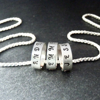 tiny hand stamped name charms on  Sterling silver mothers necklace personalized with kids names