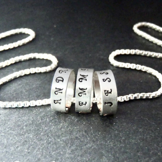 tiny hand stamped name charms on  Sterling silver mothers necklace personalized with kids names