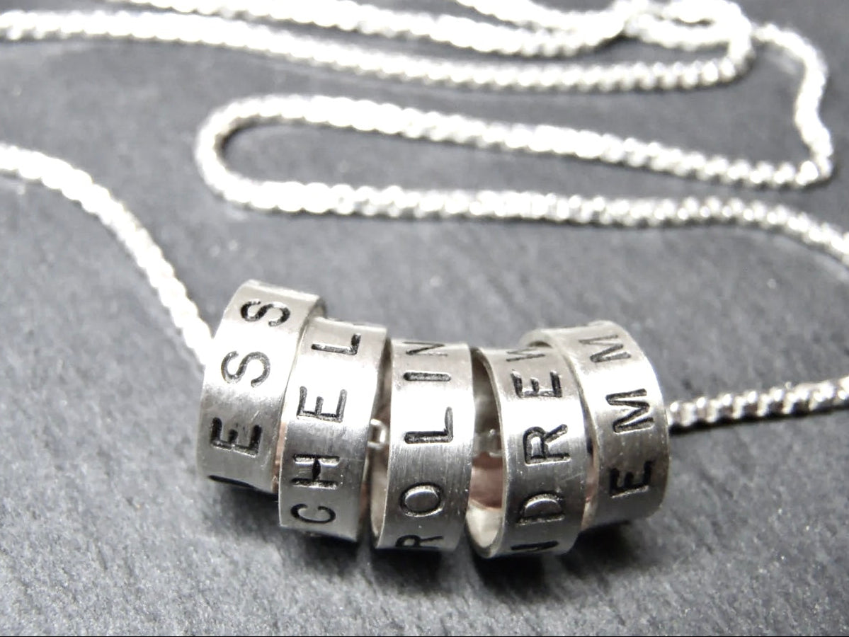 Minimalist sterling silver mom necklace with kids names on tiny ring charms - drake designs jewelry