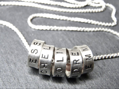 Minimalist sterling silver mom necklace with kids names on tiny ring charms - drake designs jewelry