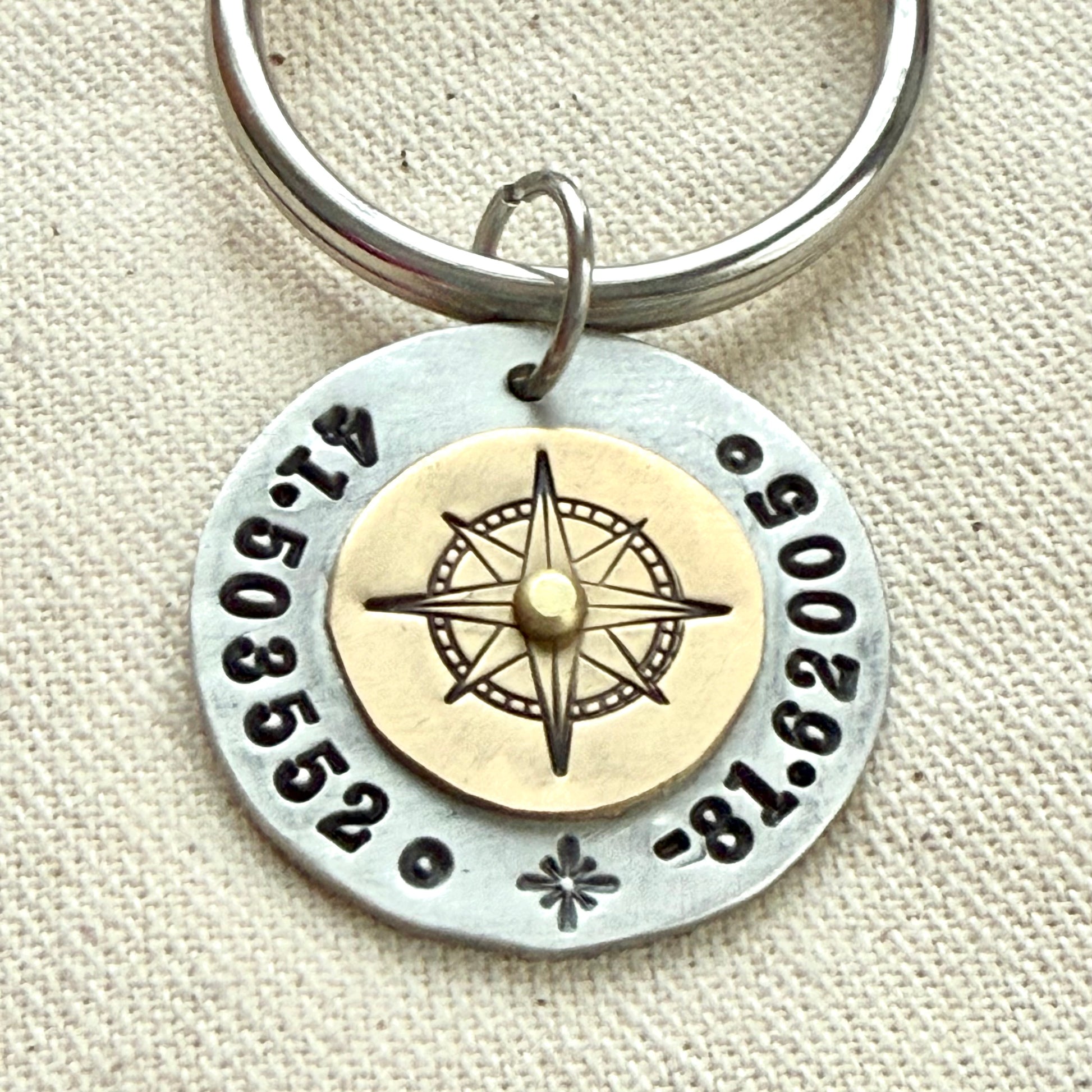 Custom coordinates keychain with gold compass riveted to silver pendant - hand stamped with personalized latitude and longitude - Drake designs jewelry