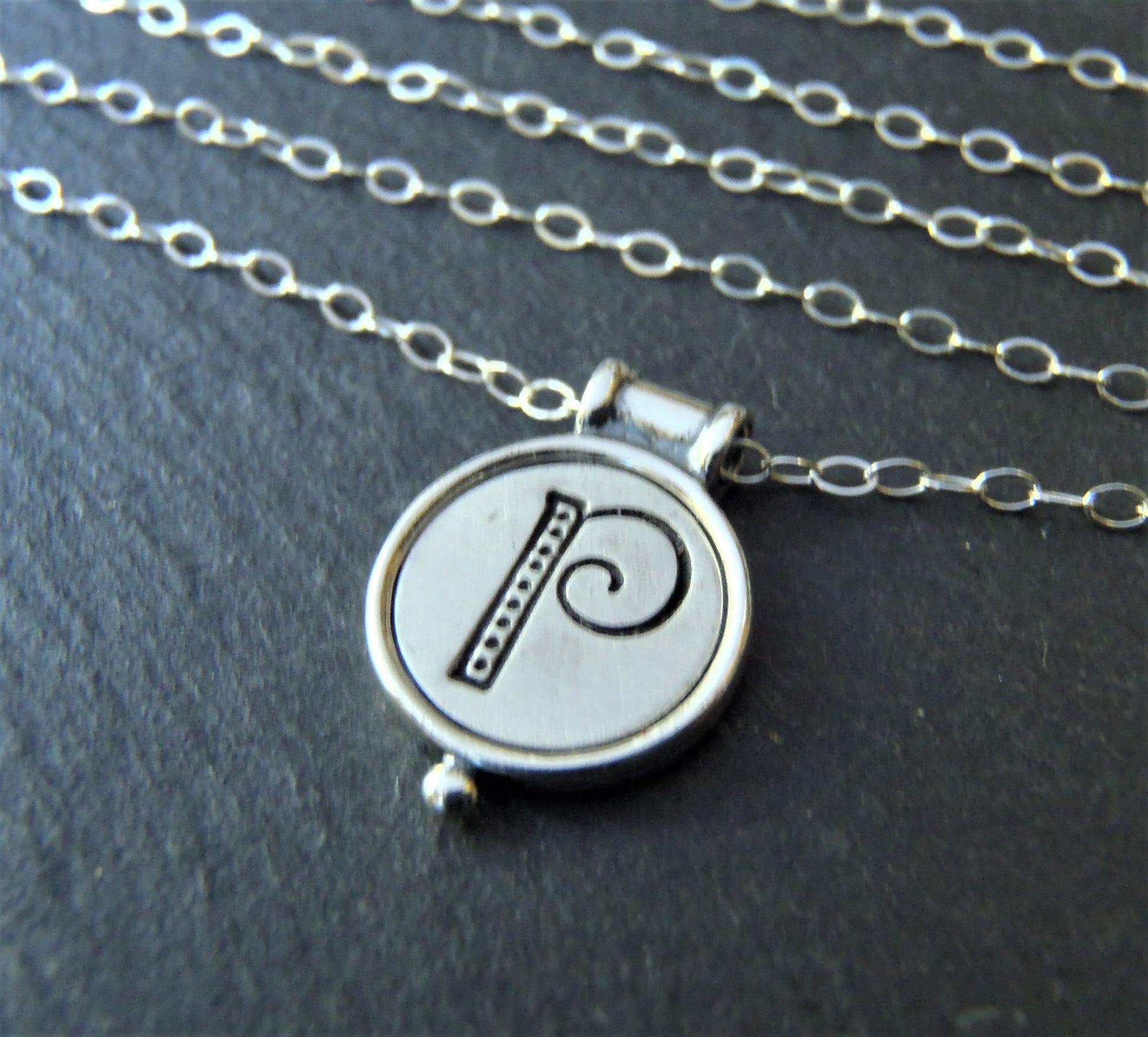 A sterling silver necklace with a personalized initial pendant on a cable chain - drake designs jewelry