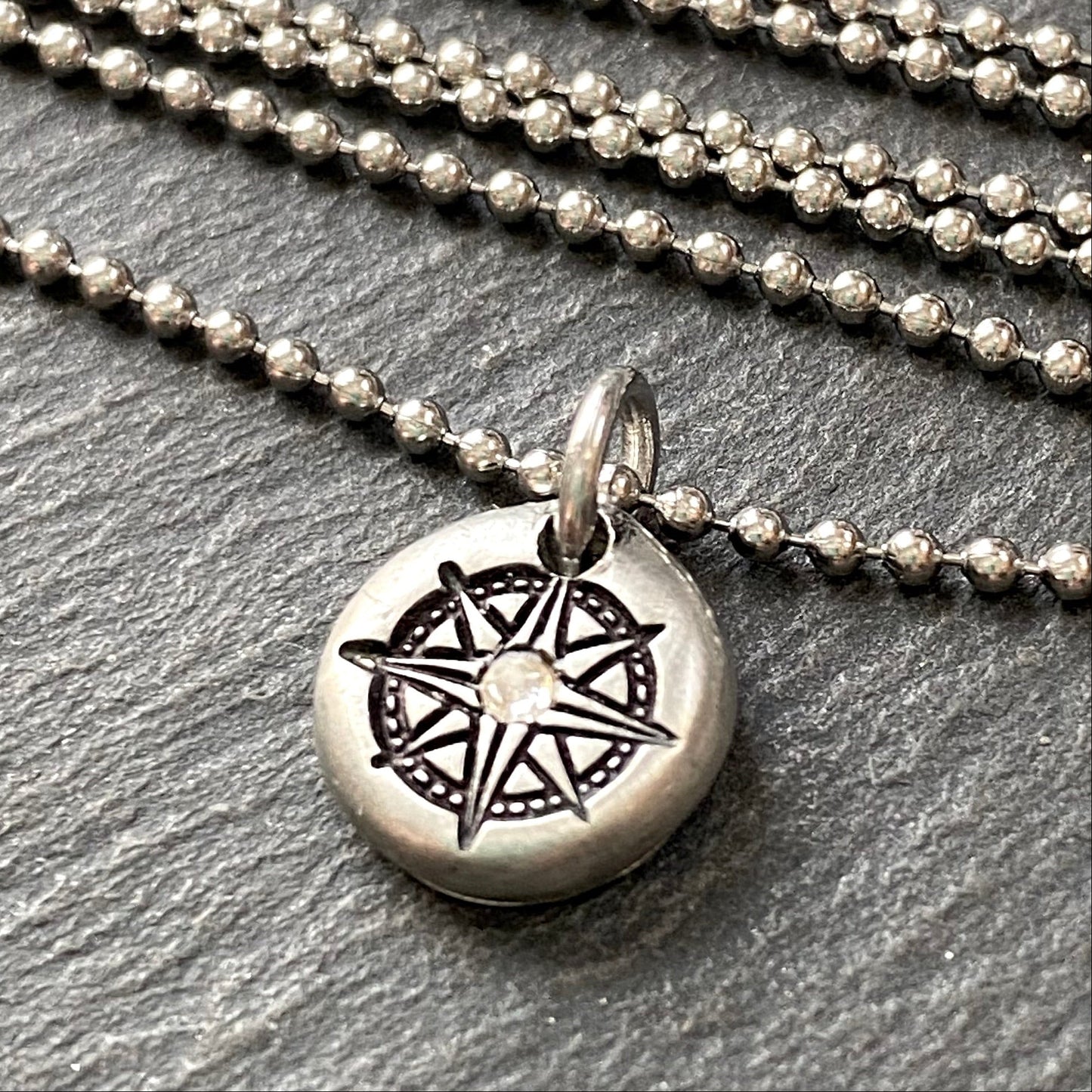 silver pebble compass necklace with hand set crystal at center - drake designs jewelry