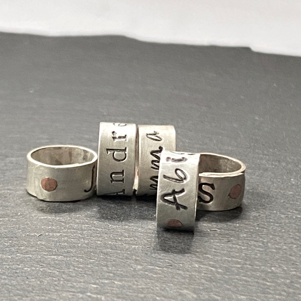 personalized sterling silver bead charm riveted by hand with copper rivet.  Hand stamped on sterling silver with your choice of font.  Custom sterling silver name charms - drake designs jewelry
