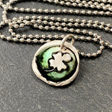 tiny clover wax seal necklace hand formed from recycled silver with green resin. drake designs jewelry
