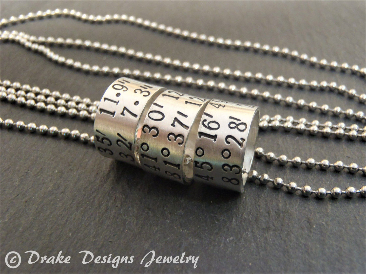 sterling silver or copper charms are personalized with latitude longitude coordinates - Drake Designs Jewelry