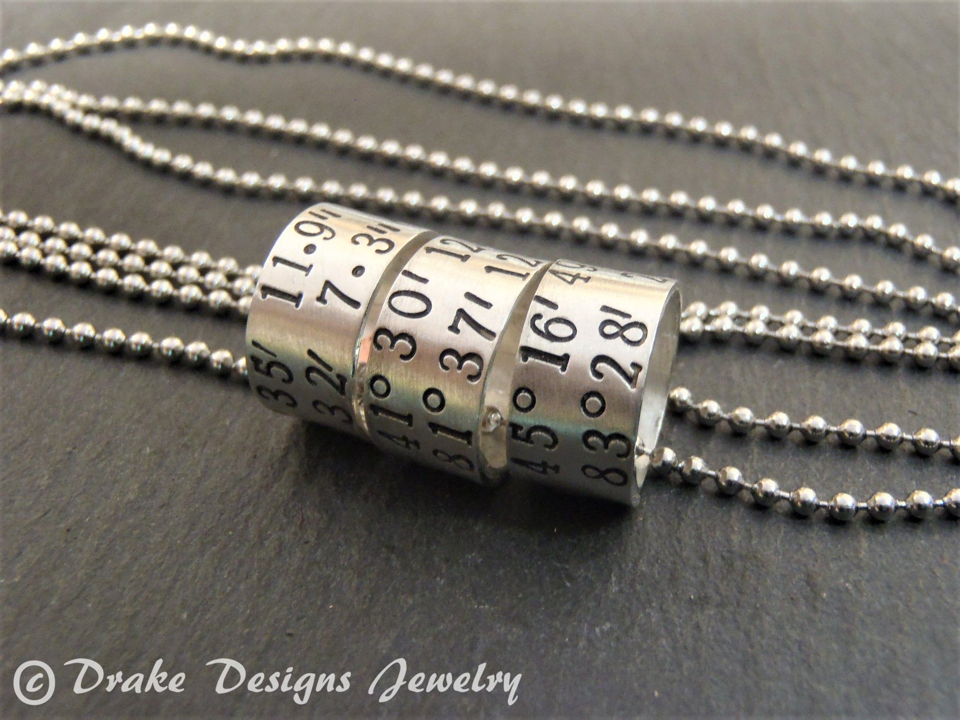 sterling silver or copper charms are personalized with latitude longitude coordinates - Drake Designs Jewelry