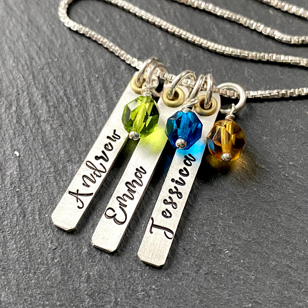 thick sterling silver bar necklace for mom with kids names and birthstones. hand stamped in script font and Sterling wire wrapped birthstone charms. mixed metal mom necklace with gold accent. Drake designs jewelry