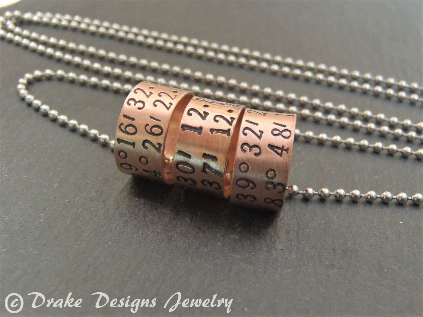 sterling silver or copper charms are personalized with latitude longitude coordinates - Drake Designs Jewelry