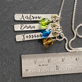 Mom necklace with kids names and birthstones.  Childrens names are hand stamped in script font on thick sterling silver bar charms and sterling silver and golden brass accent and birthstone charms are added. drake designs jewelry