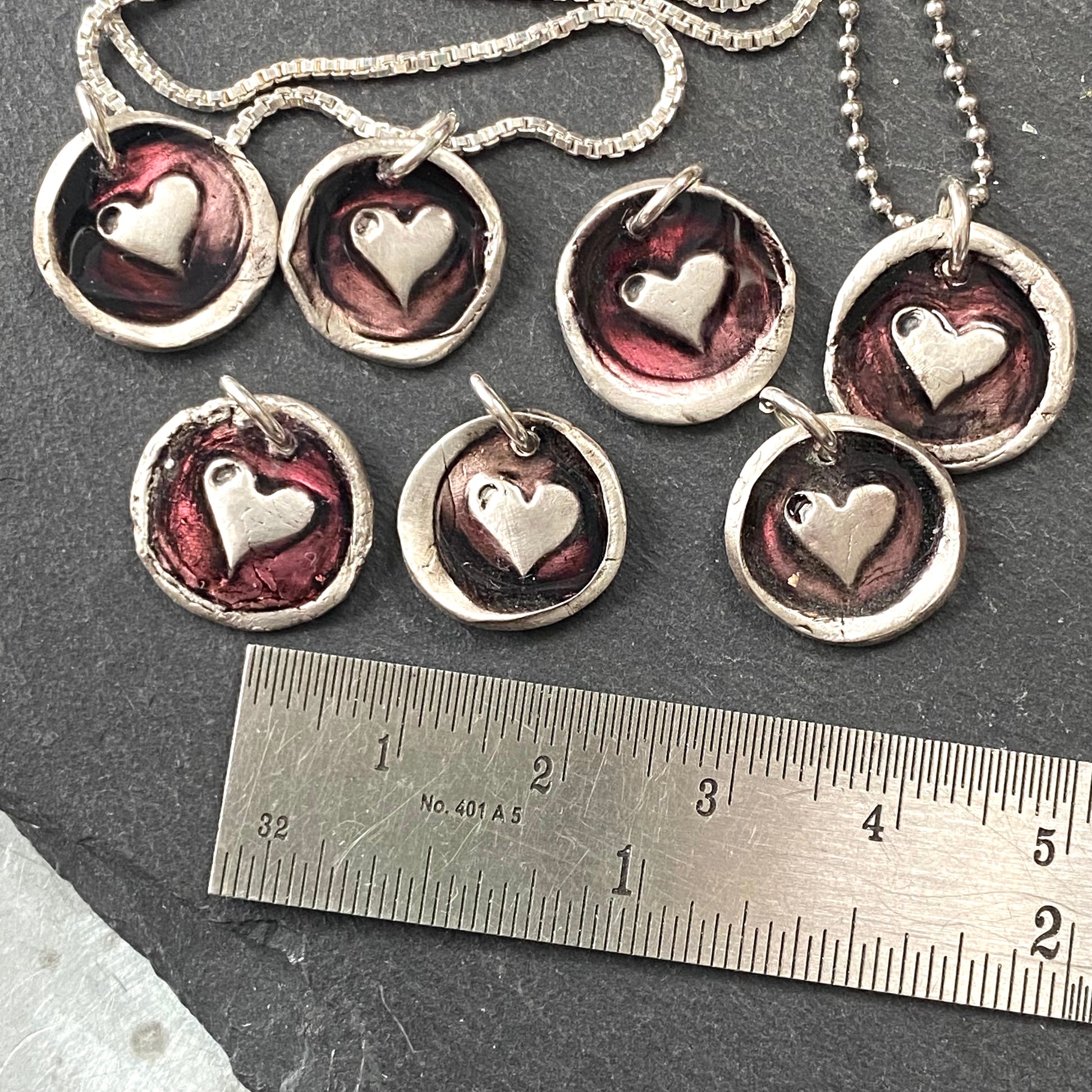 tiny hand crated wax seal heart necklace with red resin accent.  drake designs jewelry