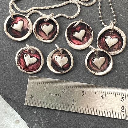 tiny hand crated wax seal heart necklace with red resin accent.  drake designs jewelry