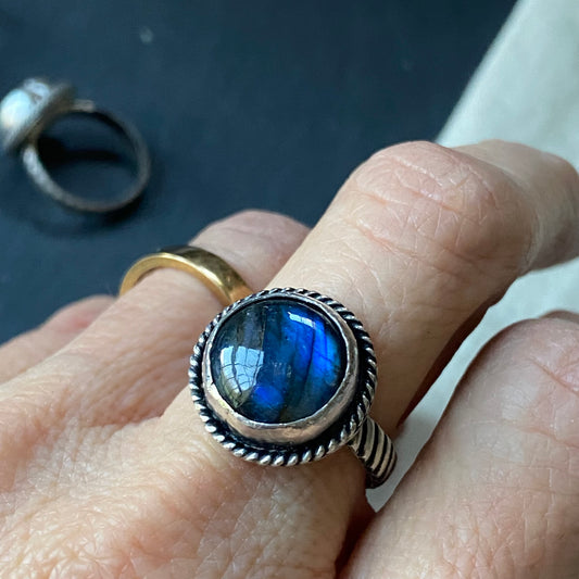 sterling silver labradorite ring hand crafted with rope band .  Labradorite with flash is hand set in sterling silver bezel - drake designs jewelry