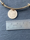 gold queen bee bracelet with rope edge border stamped on pendant. drake designs jewelry