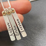 sterling silver thick vertical mom necklace with kids names hand stamped in decorative script font. drake designs jewelry