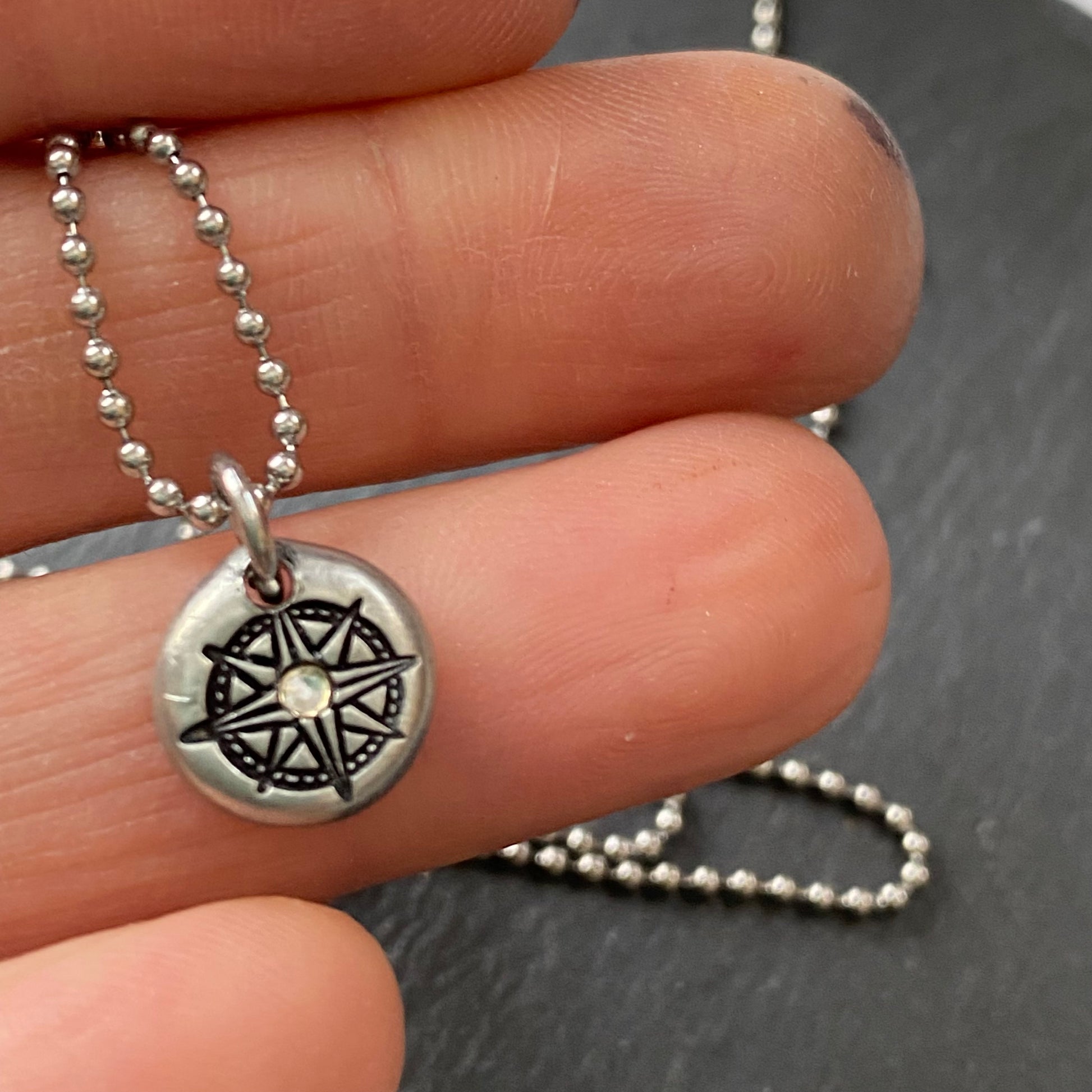 silver pebble compass necklace with hand set crystal at center - drake designs jewelry