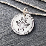 Queen bee necklace with rope edge border. hand stamped sterling silver bee with crown pendant. drake designs jewelry