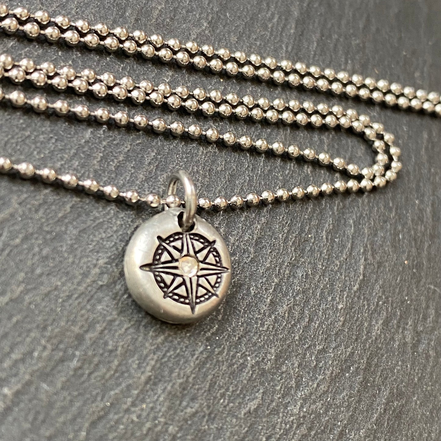 silver pebble compass necklace with hand set crystal at center - drake designs jewelry
