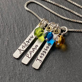 Mom necklace with kids names stamped on thick sterling silver and gold brass charms.  Birthstone charms are added with hand wrapped  Czech fire polished beads. Drake designs jewelry
