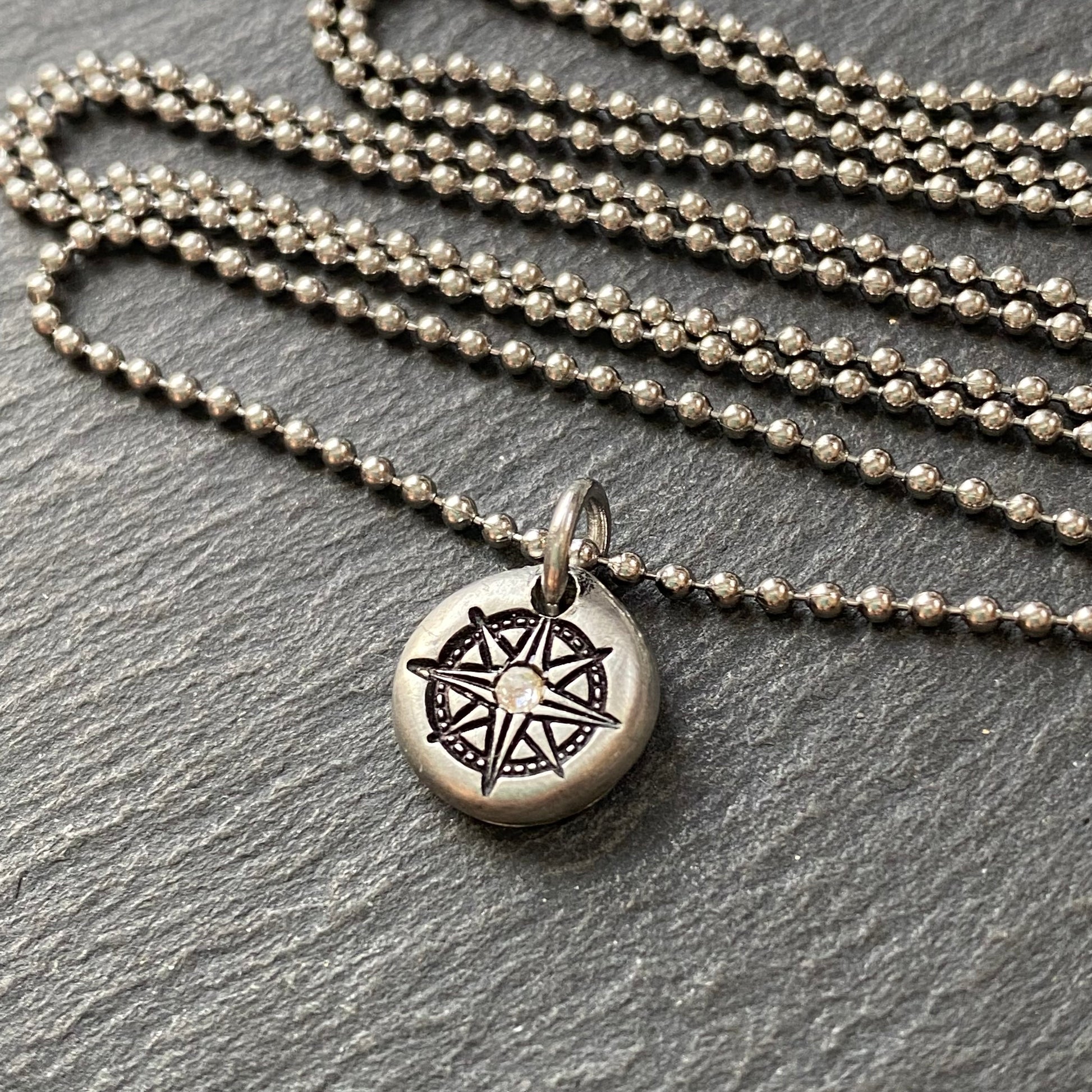 silver pebble compass necklace with hand set crystal at center - drake designs jewelry
