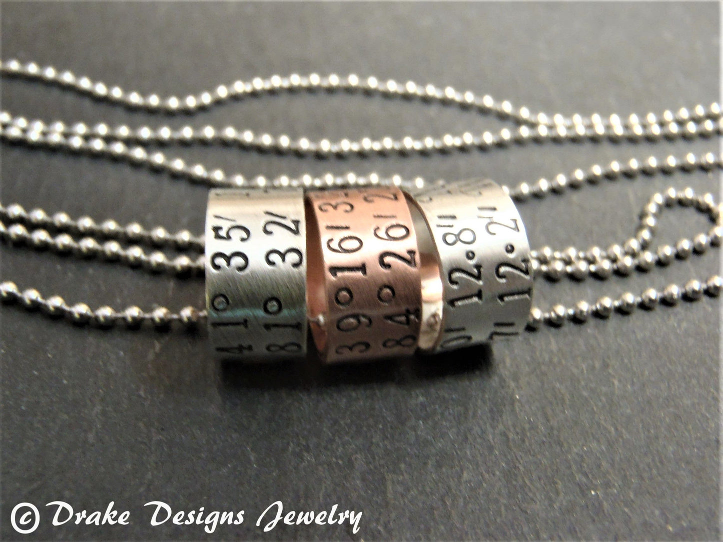 sterling silver or copper charms are personalized with latitude longitude coordinates - Drake Designs Jewelry